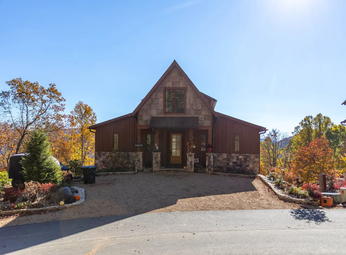 A welcoming exterior view of the front entrance, with a stone façade and landscaped garden, providing secure and ample parking nearby. The inviting entryway underscores the property's ease of access and security for families and their pets.
